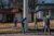 A team of five people in light winter coats and hats walks along a neighborhood Memphis street while canvassing
