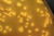 Yellow microscopic image of yersinia pseudotuberculosis bacteria cultured in a Petri dish. Some bacteria are in single circles, other cluster together.