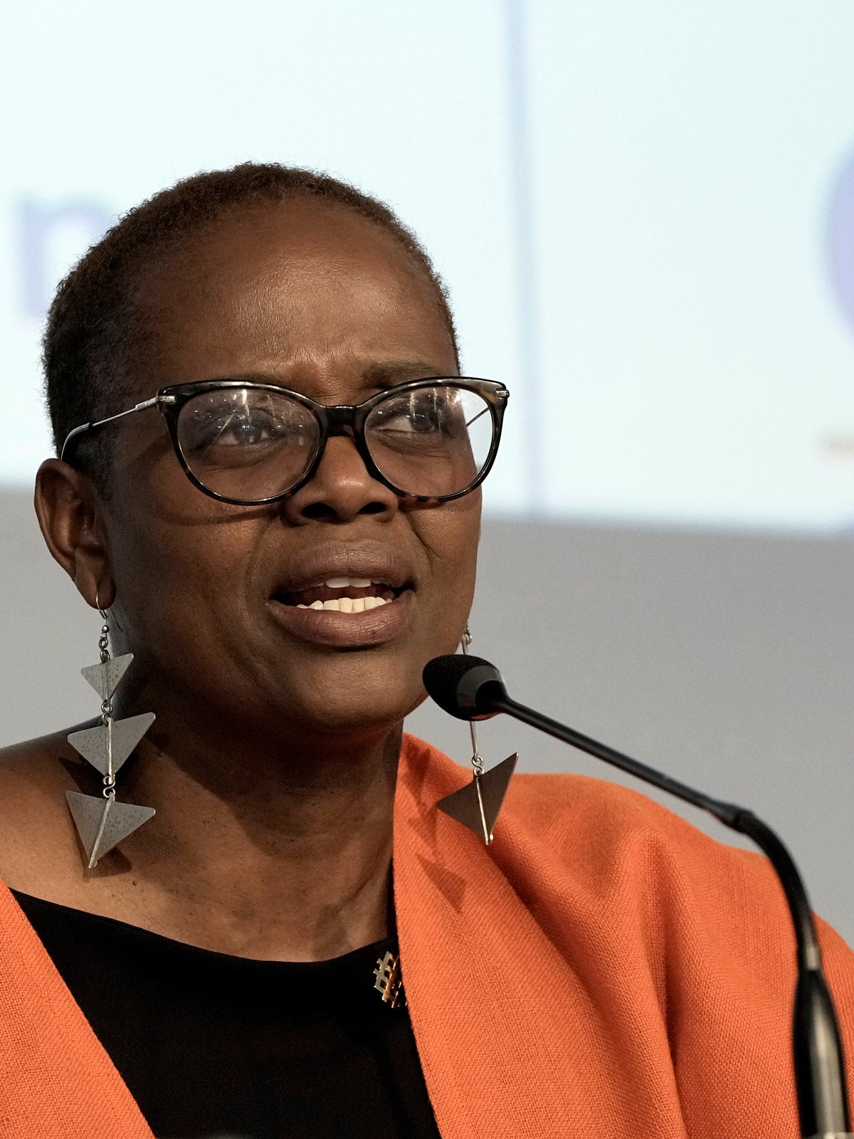 Wanjira Mathai, Vice President and Regional Director for Africa, World Resources Institute, sits on a panel and speaks into a microphone.