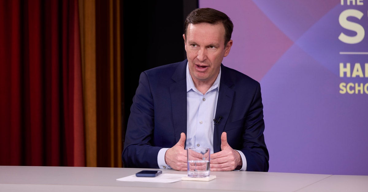 Senator Chris Murphy seated and speaking at a panel event.