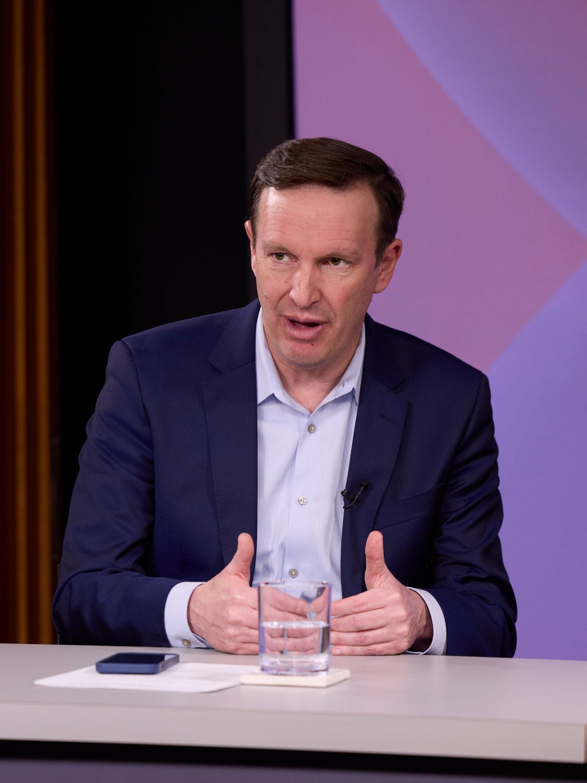Senator Chris Murphy seated and speaking at a panel event.
