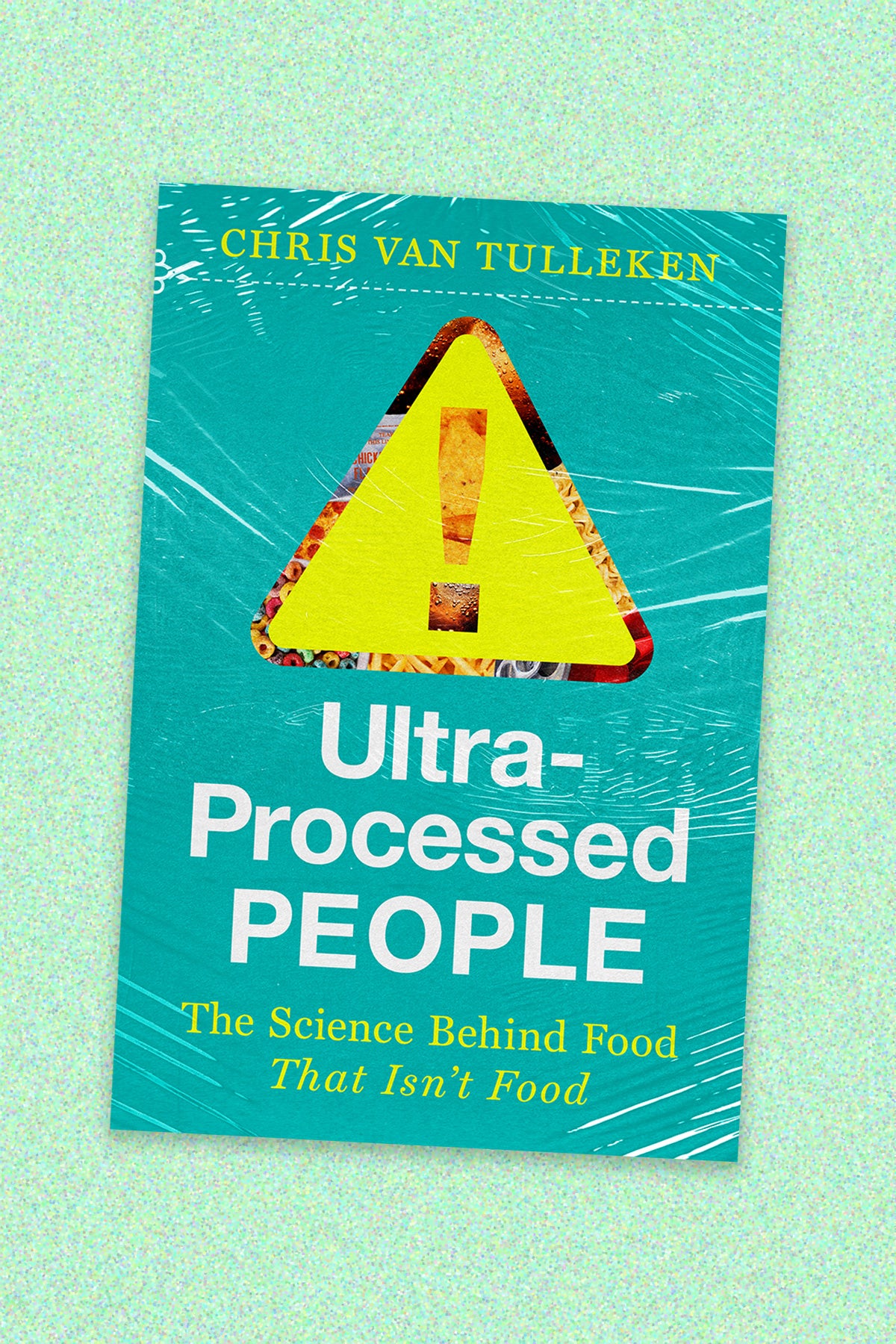 Book cover of “Ultra-Processed People: The Science Behind Food That Isn’t Food” By Chris Van Tulleken. The book cover design is a photo illustration of a yellow warning sign with processed food behind it. The illustration and text (white and yellow) sit on a teal plastic-wrap looking package. The book cover is on jade speckled background.
