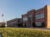 Exterior of Abbott Middle School in Waukegan, Illinois: two story brick building with an American flag and green lawn.