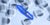 Photo illustration: A cut-out image of a syringe lays on top of a pile of “I voted” stickers.