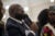 Founder of Heal 901 K. Durell Cowan speaks into a microphone at a conference. He wears a blue suit and is bald.