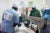 A medical team wearing blue scrubs performs a cathartic surgery in Somalialand in 2012. The scrubs have the IHH and World Health Logo organizations on the back.