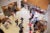Birds-eye view of orientation in the Kresge lobby. Students stand in line waiting to receive orientation materials. Others stand in small groups.