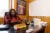 Timaka James Jones, a Mississippi state representative sits at her desk talking to the camera. Her office is wood paneled and has a map of the district on the wall, and books on the desk.