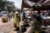 Women buy and sell food at a bustling market in Bangui, Central Africa.