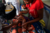 A woman holds a baby who is receiving a vaccine shot