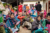 A group of Nepalese women wait outside for medical car. They are wearing tradidional dresses, scarfs and saris.